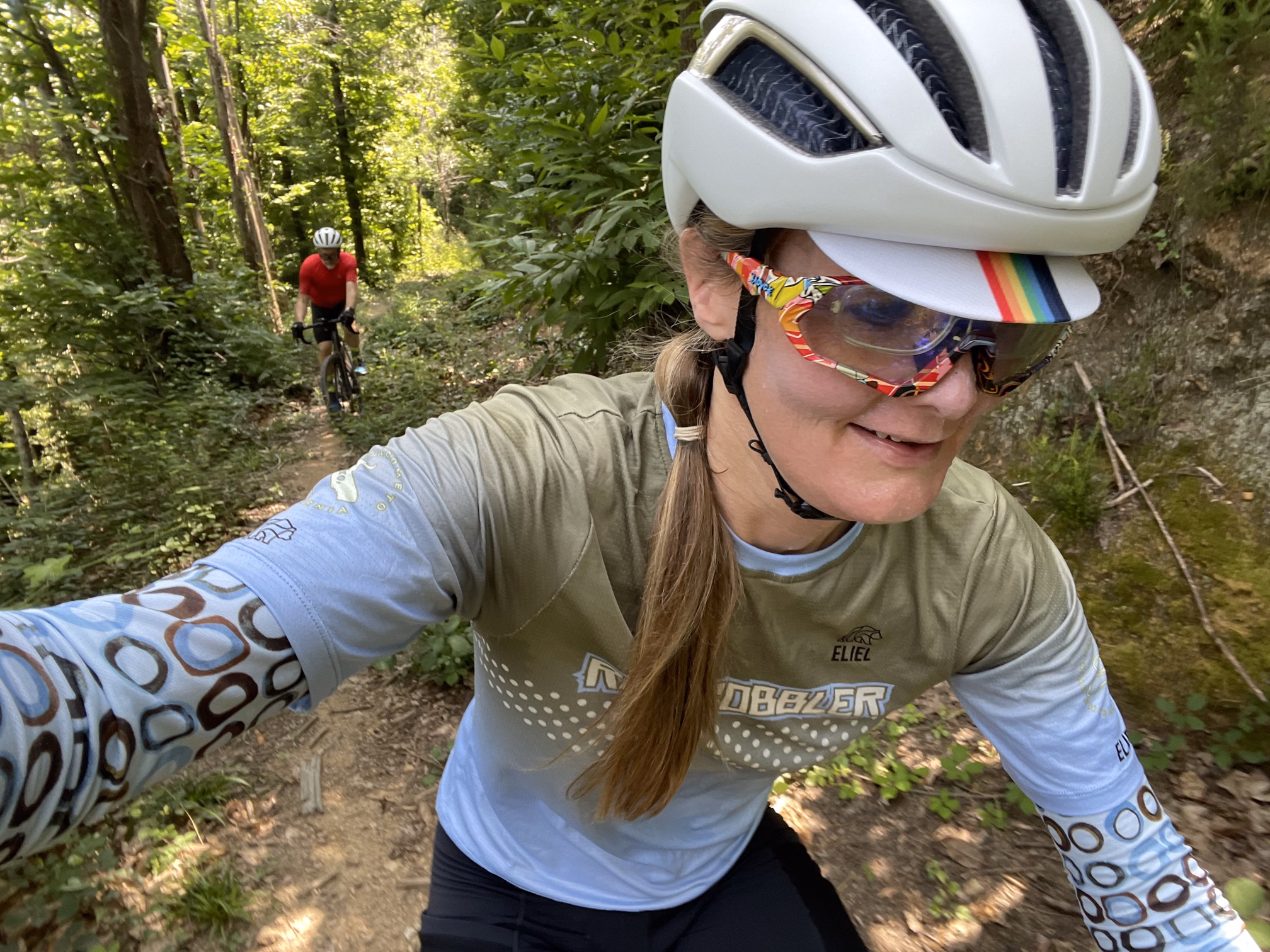 tracey & hunter biking through forest