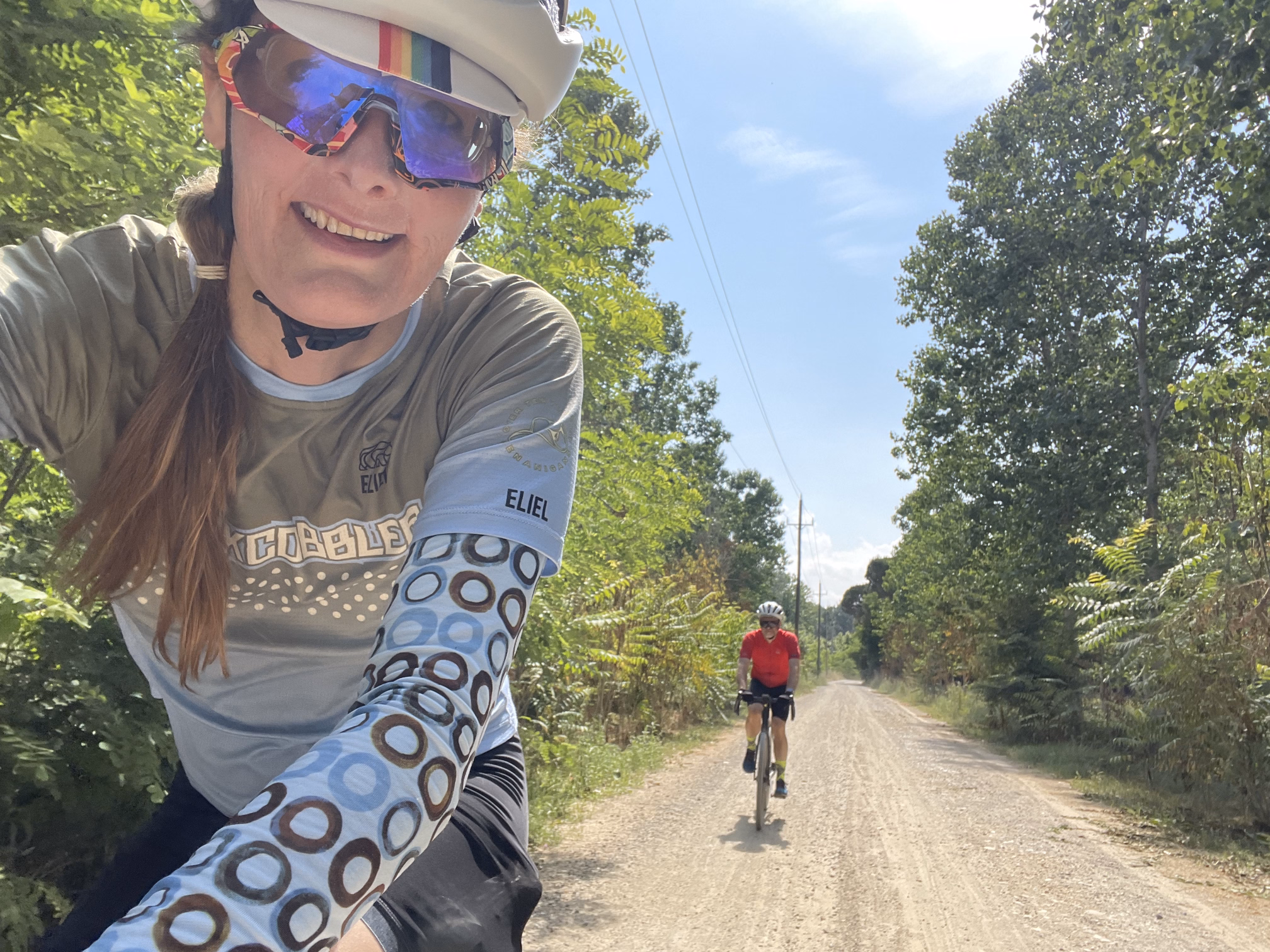 tracey & hunter biking a dirt road