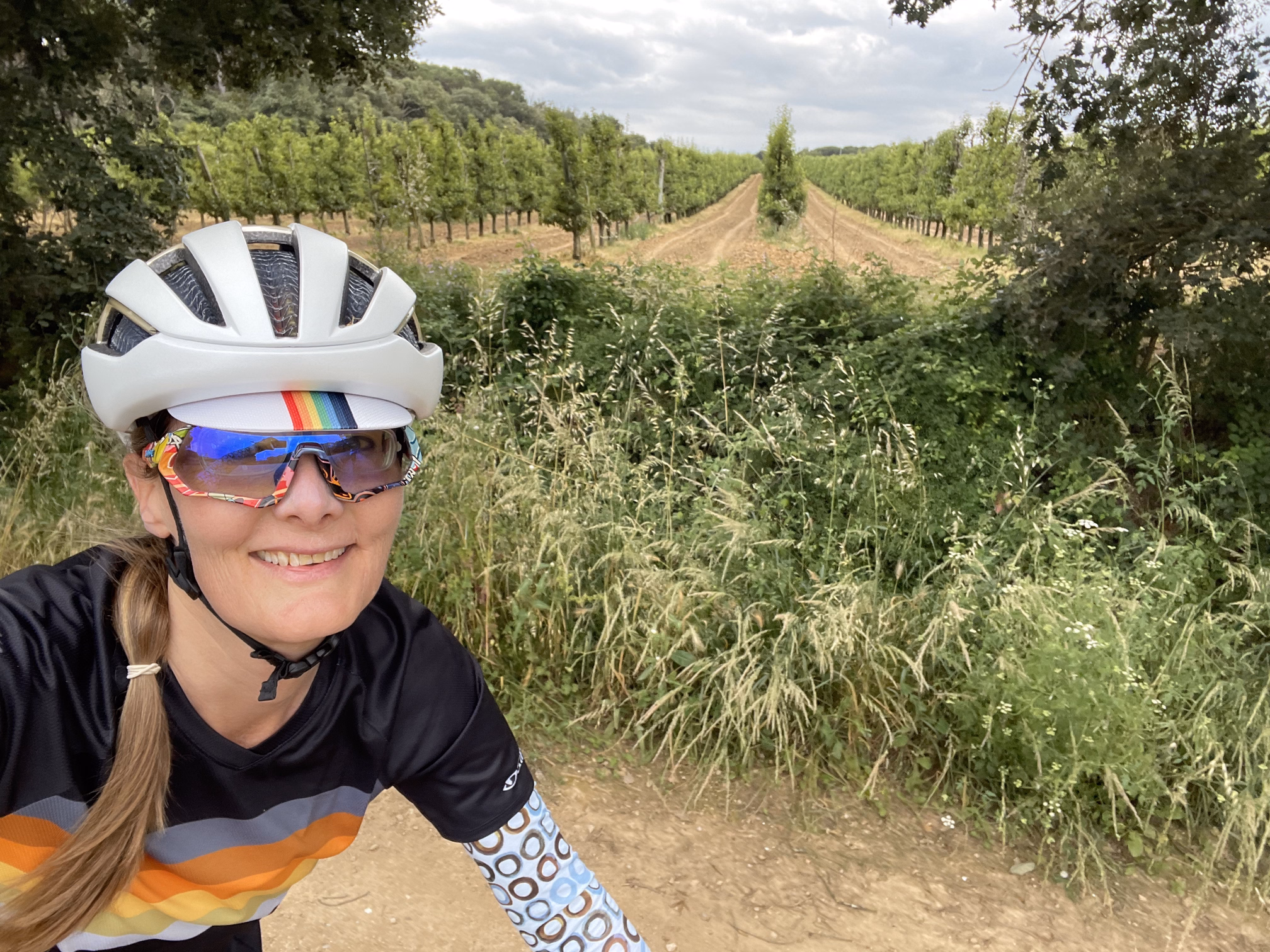 tracey biking by an orchard