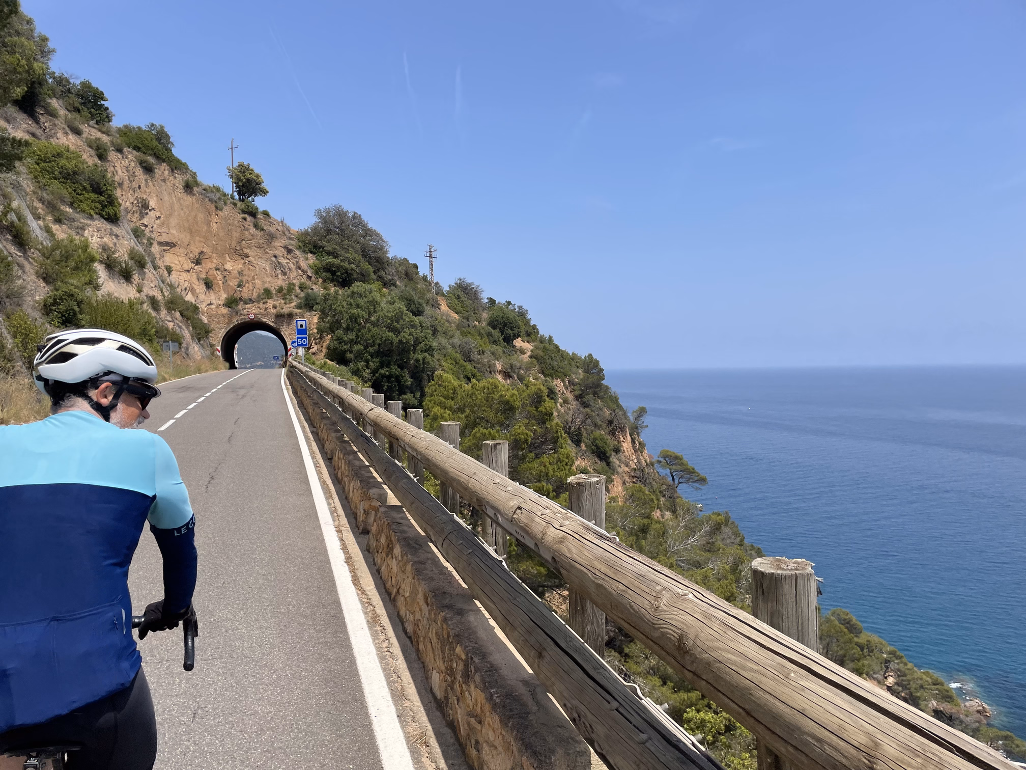 hunter biking towards tunnel overlooking the sea