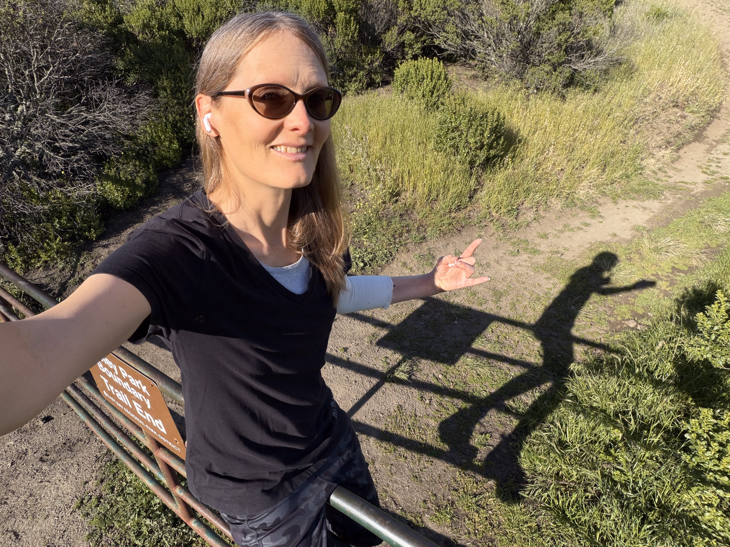 tracey selfie atop cow fence