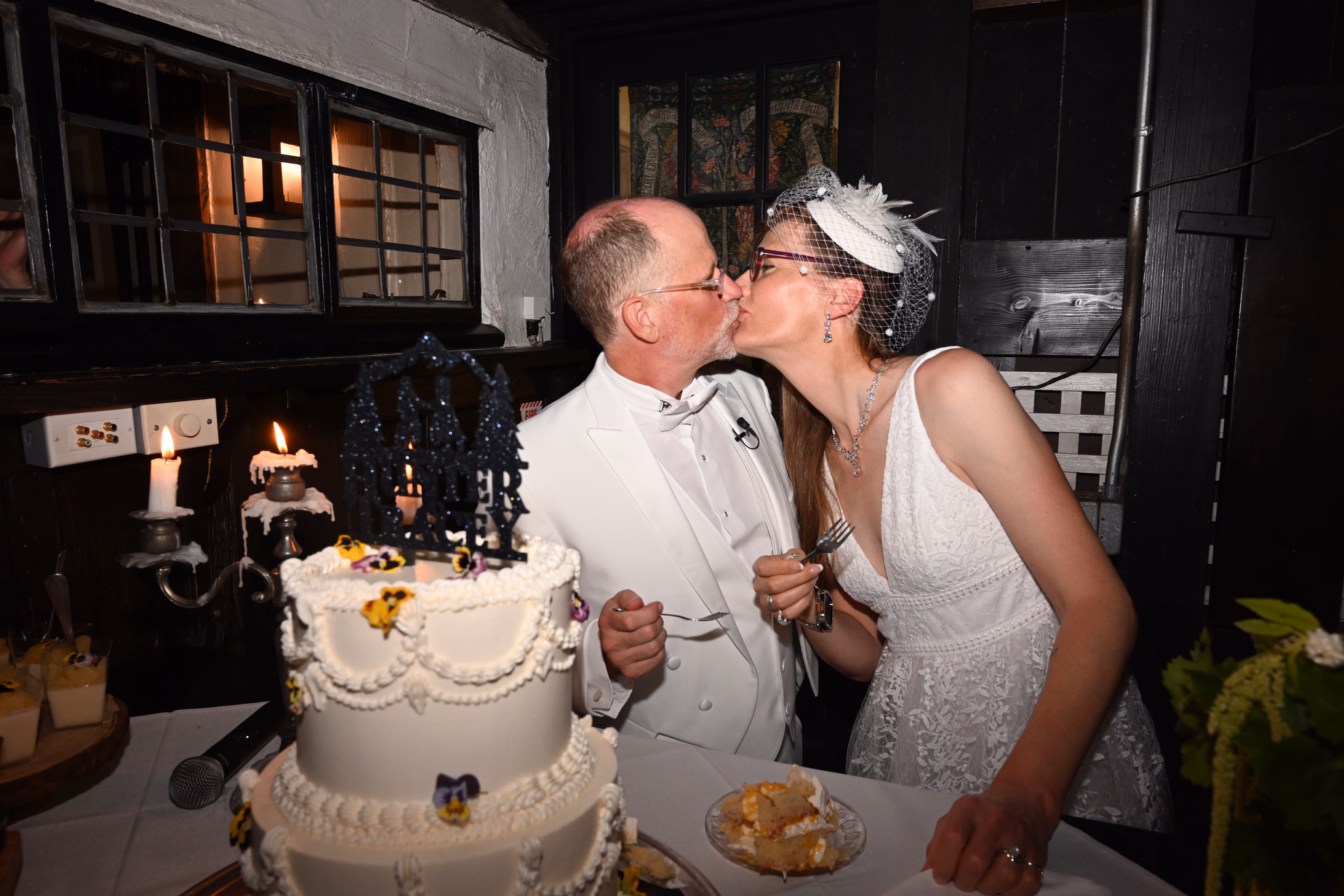 wedding couple kissing at cake