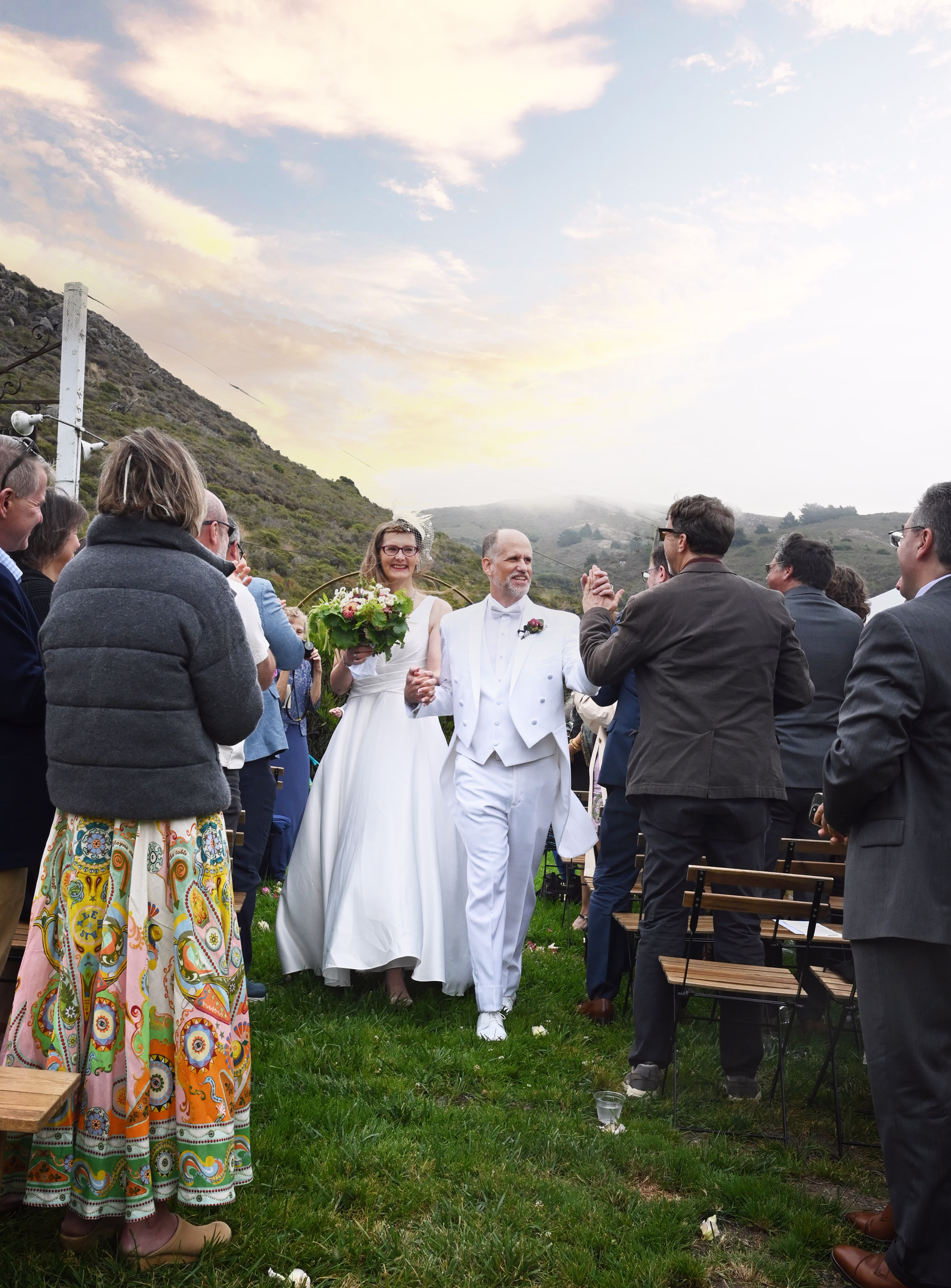 married couple coming down the aisle